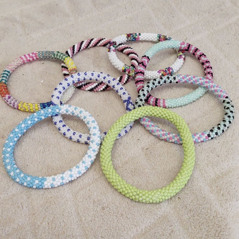 Eight handmade beaded bracelets.